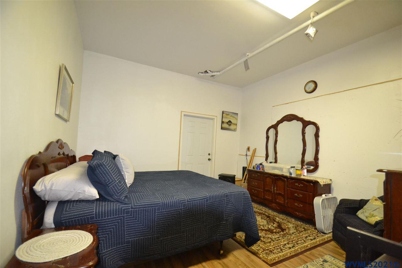 1690 Bayocean Road Northwest Tillamook, OR 97141 - Photo 12 of 25 a bedroom with a bed and wooden floor