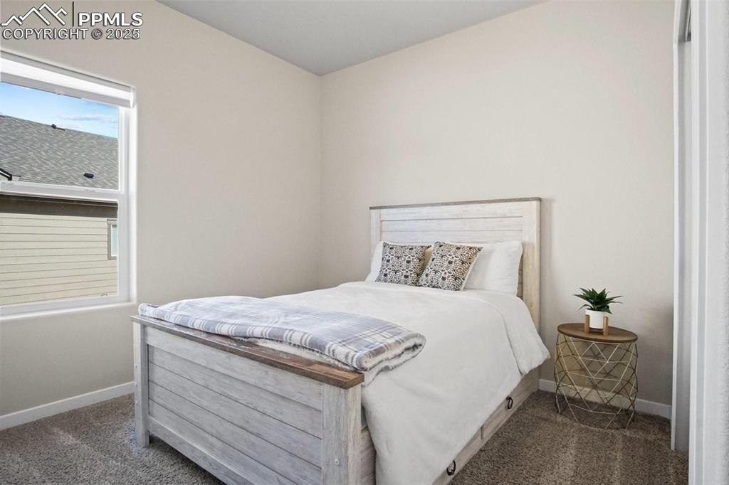 10052 Bracknell Place Peyton, CO 80831 - Photo 20 of 36 a bedroom with a bed and a window