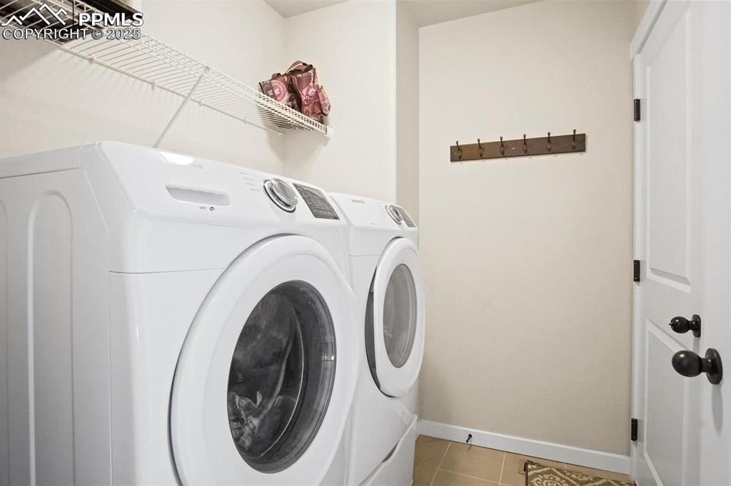 10052 Bracknell Place Peyton, CO 80831 - Photo 21 of 36 a utility room with dryer and washer
