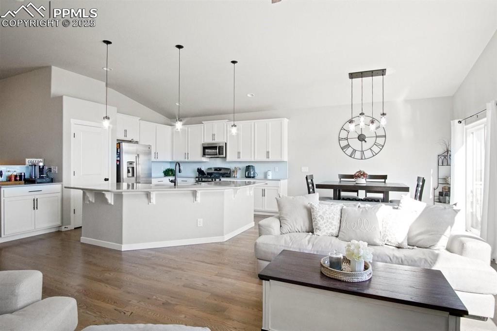 10052 Bracknell Place Peyton, CO 80831 - Photo 8 of 36 a kitchen with white cabinets and refrigerator