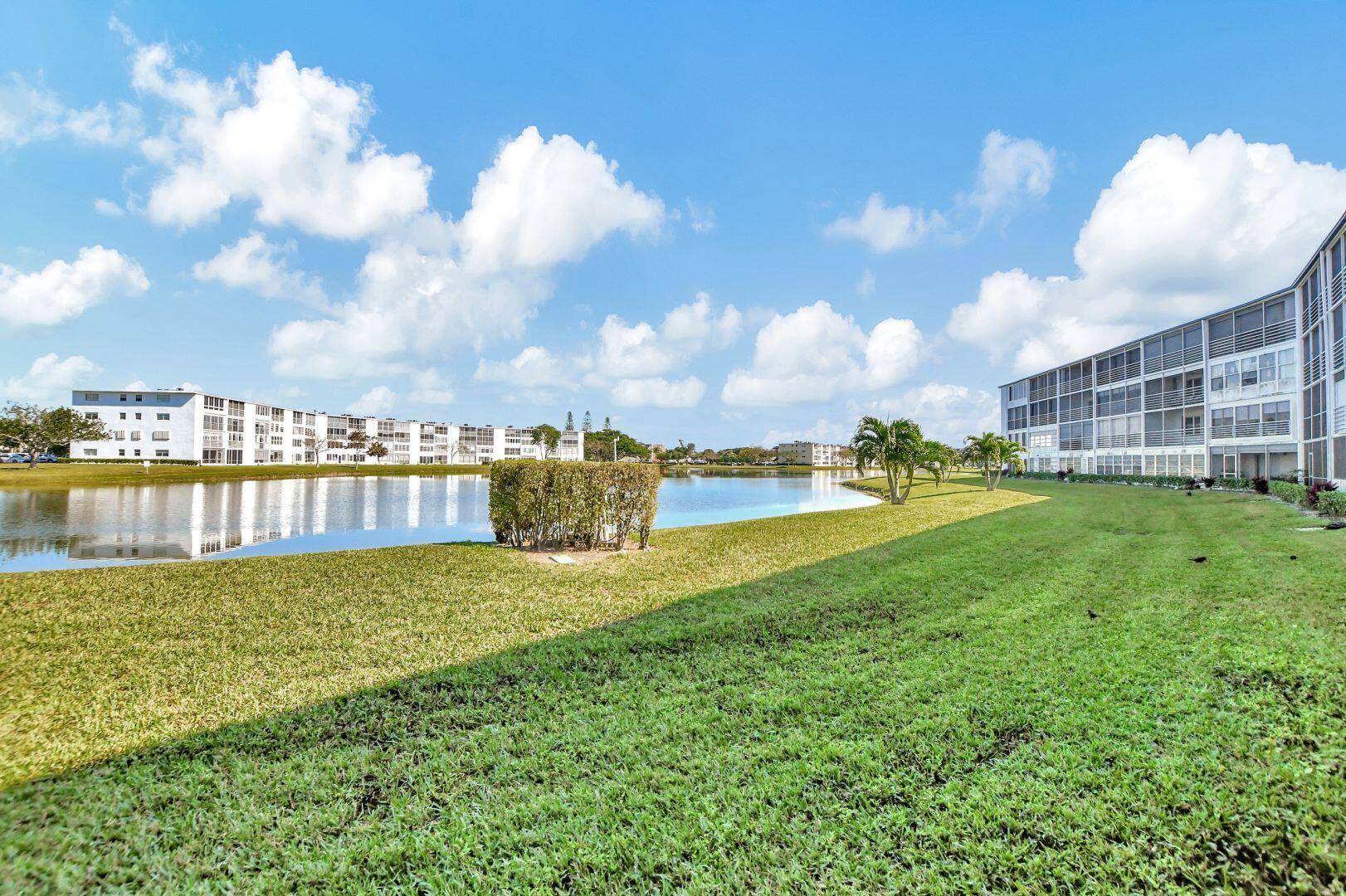 1047 Exeter C Boca Raton, FL 33434 - Photo 14 of 37 a view of a house with a yard and lake view