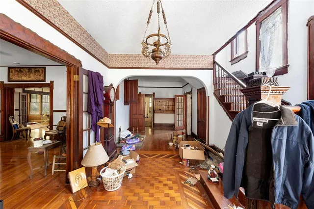 a view of a hall with dining area and chandelier