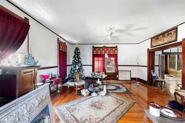a living room with lots of furniture wooden floor and a table