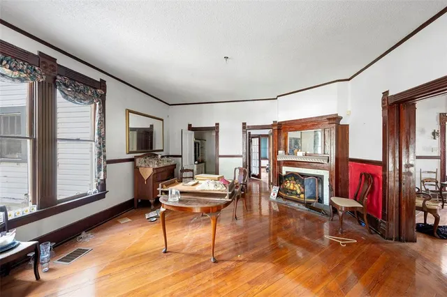 a living room with furniture a window and a flat screen tv