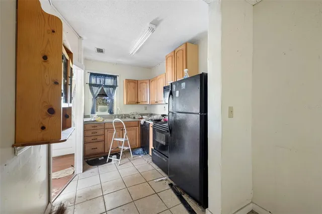 a kitchen with stainless steel appliances a refrigerator and a stove