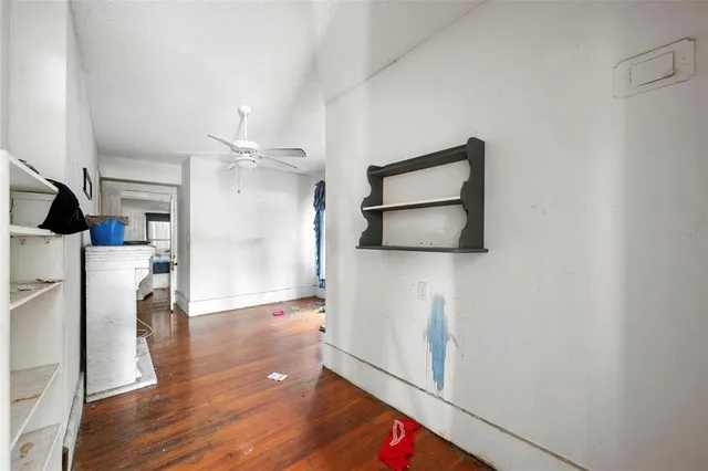 a view of a hallway with wooden floor and staircase