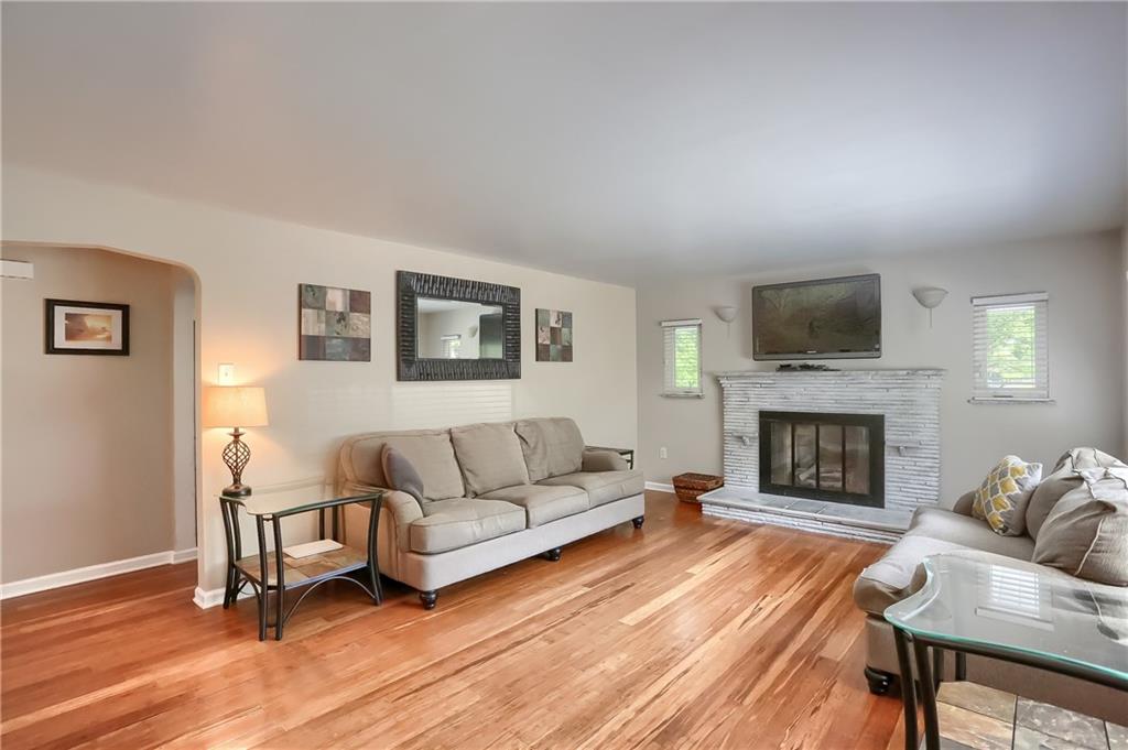 3275 Ridge Rd Extension Freedom, PA 15042 - Photo 2 of 25 Beautiful Bamboo hardwood floors sprawl the main level and glisten with abundant natural sunlight flooding the home. A custom fireplace with white brick surround is the focal point of this space.