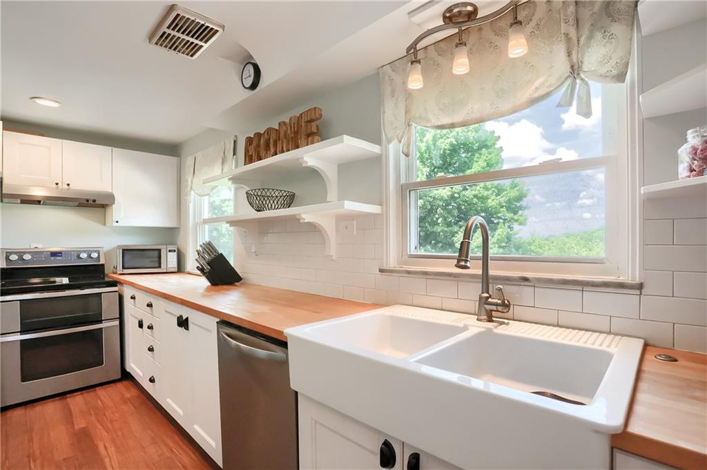 3275 Ridge Rd Extension Freedom, PA 15042 - Photo 5 of 25 Meal prep and clean will be a breeze with the stainless steel double oven, expansive counters and large farm house sink.