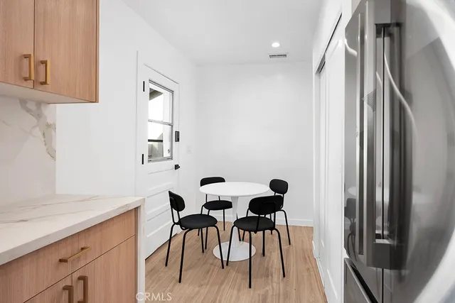 a bedroom with two beds and a potted plant