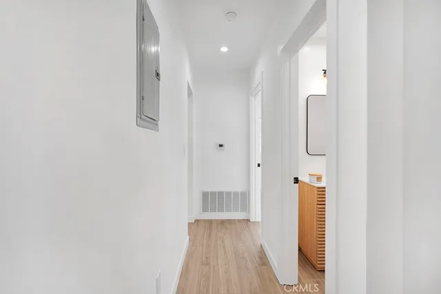 a bathroom with a sink a glass door shower and mirror