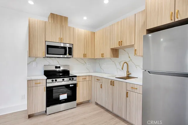 a view of kitchen with stainless steel appliances refrigerator oven