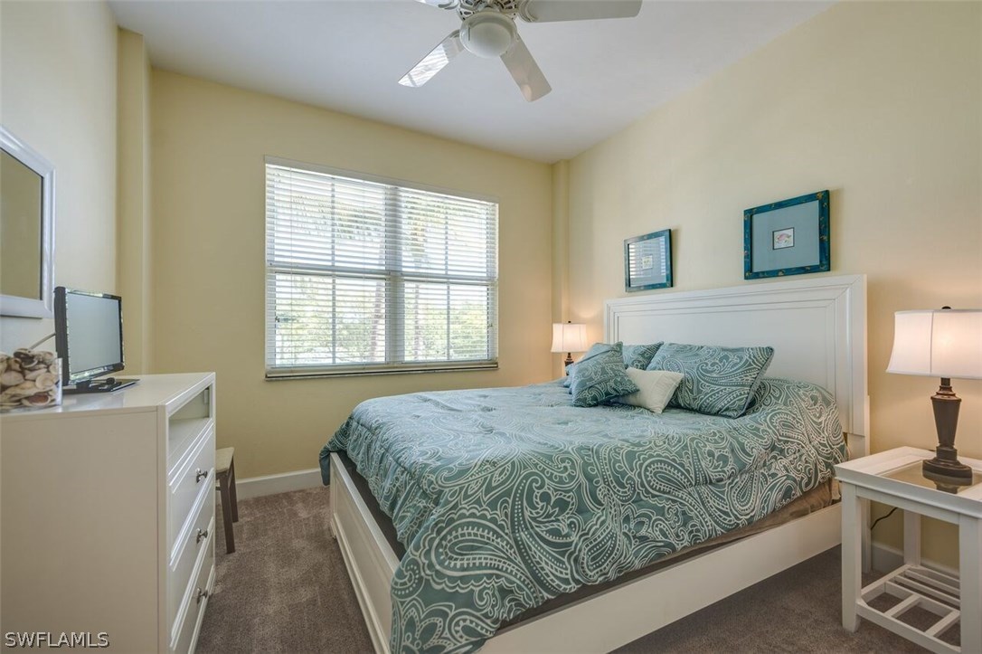 2060 Matecumbe Key Road, Unit 2207 Punta Gorda, FL 33955 - Photo 11 of 21 a bedroom with a bed and a chandelier