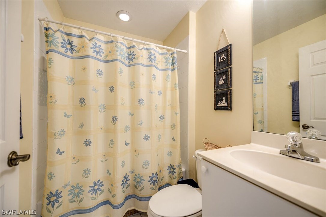 2060 Matecumbe Key Road, Unit 2207 Punta Gorda, FL 33955 - Photo 12 of 21 a bathroom with a sink toilet and shower