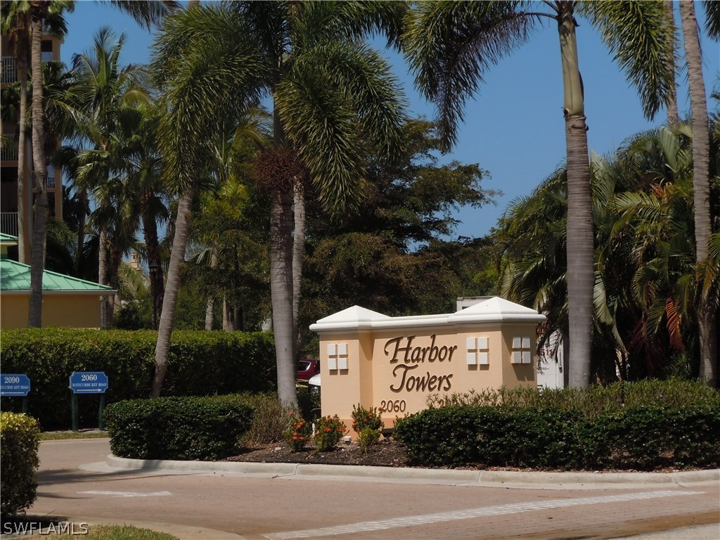2060 Matecumbe Key Road, Unit 2207 Punta Gorda, FL 33955 - Photo 20 of 21 a view of a white house with a yard and palm trees
