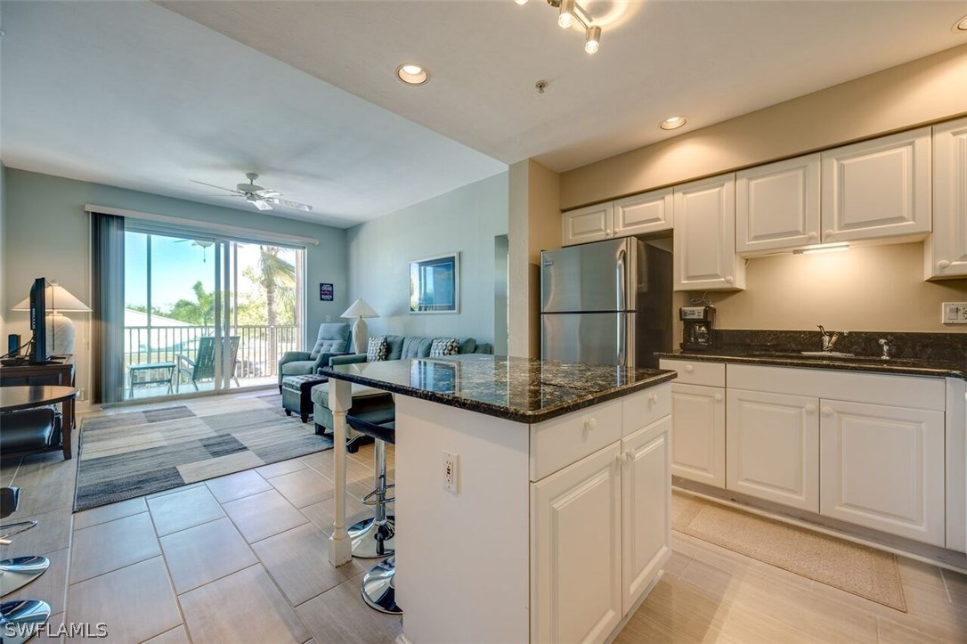 2060 Matecumbe Key Road, Unit 2207 Punta Gorda, FL 33955 - Photo 3 of 21 a kitchen with stainless steel appliances granite countertop a stove a sink and a refrigerator