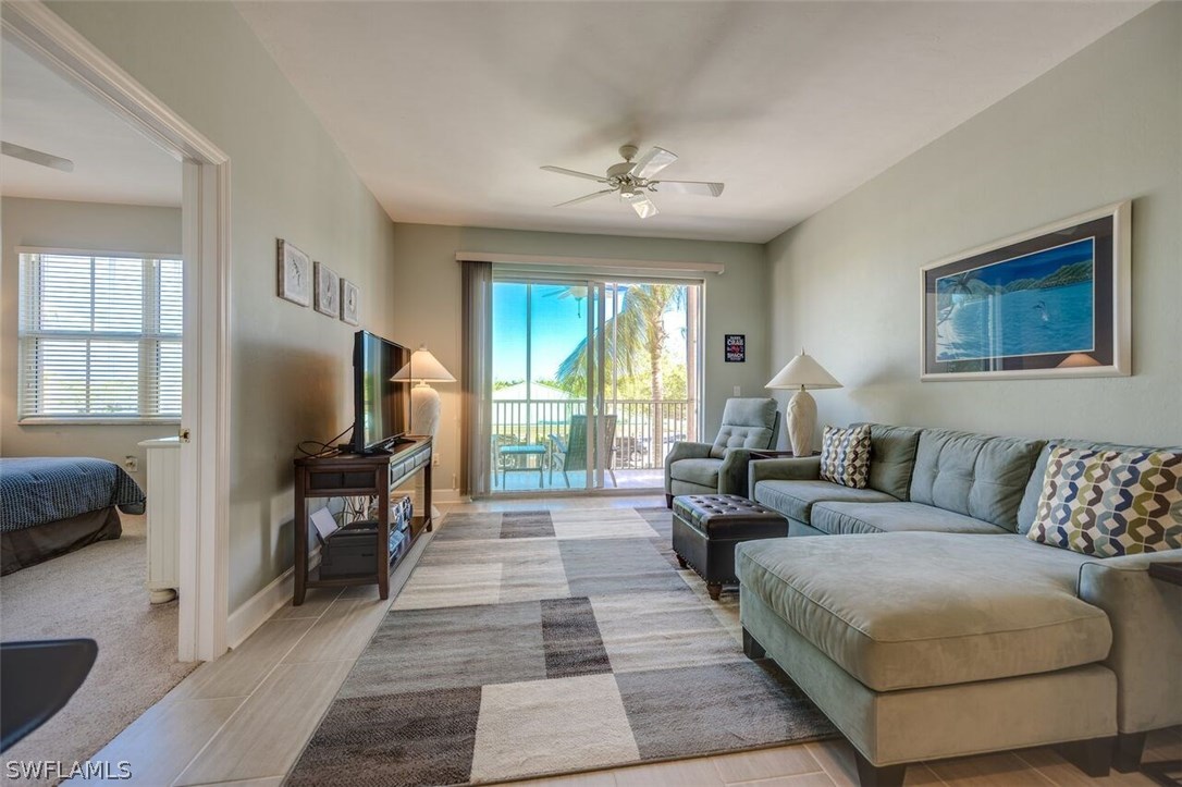 2060 Matecumbe Key Road, Unit 2207 Punta Gorda, FL 33955 - Photo 8 of 21 a living room with furniture and a flat screen tv