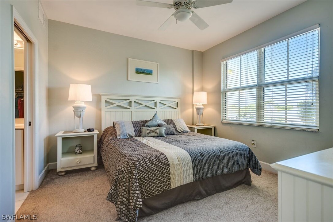 2060 Matecumbe Key Road, Unit 2207 Punta Gorda, FL 33955 - Photo 9 of 21 a bedroom with a bed and a chandelier