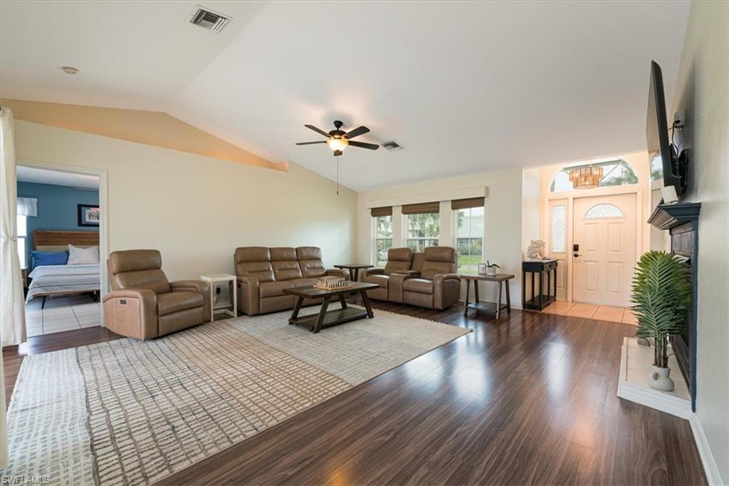 8312 Tahiti Road Fort Myers, FL 33967 - Photo 7 of 43 Bright Spacious Living Room with Fireplace & Sliders that open to Pool Lanai area.