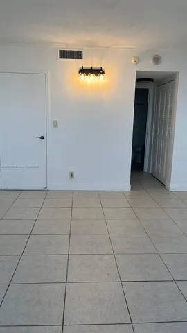 a view of a livingroom with an empty space and a window