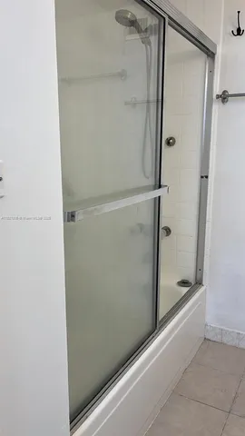 a bathroom with a glass shower door