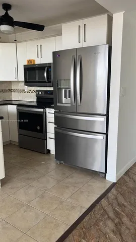 a kitchen with stainless steel appliances a refrigerator and a stove