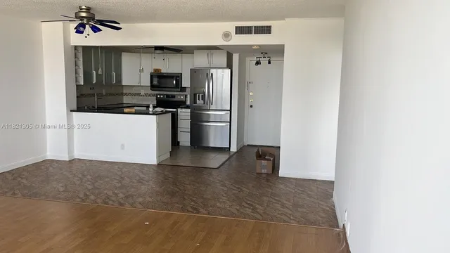 a view of a kitchen with refrigerator and microwave