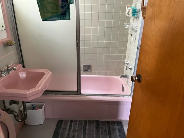 a bathroom with a sink a toilet and a mirror