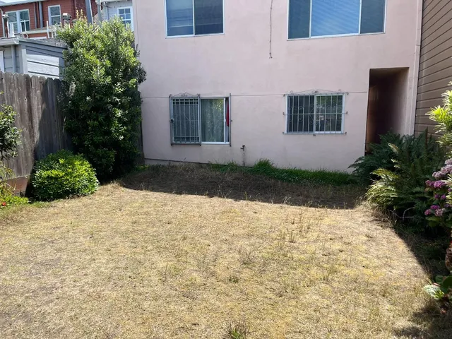 a view of white house with a yard