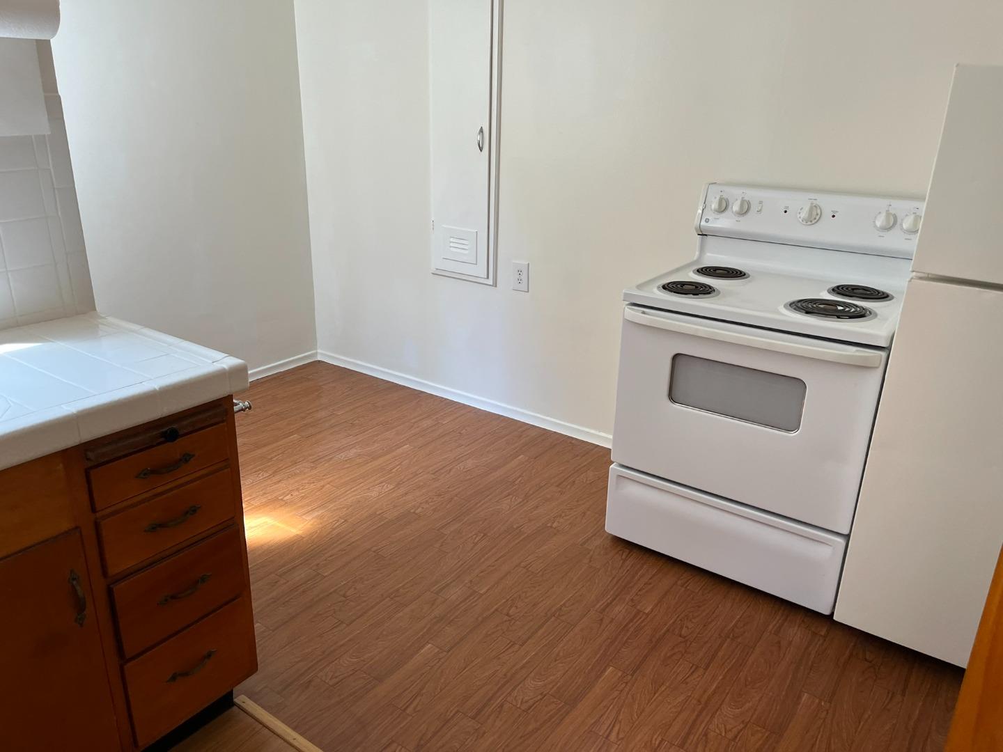 2028-2030 Taraval Street San Francisco, CA 94116 - Photo 5 of 18 a kitchen with granite countertop white cabinets and white appliances