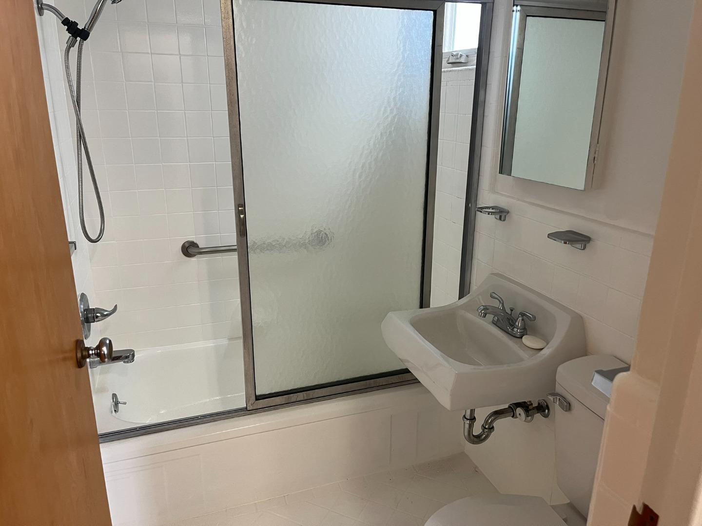 2028-2030 Taraval Street San Francisco, CA 94116 - Photo 9 of 18 a bathroom with a sink and mirror with toilet