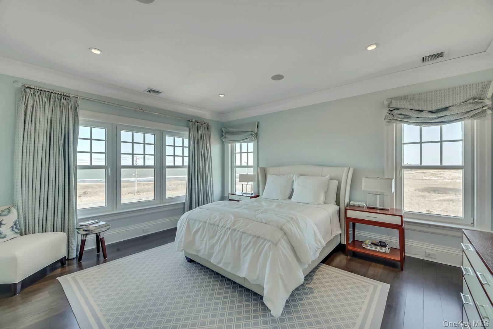 19 Dune Road East Quogue, NY 11959 - Photo 12 of 19 a bedroom with a large bed and a window