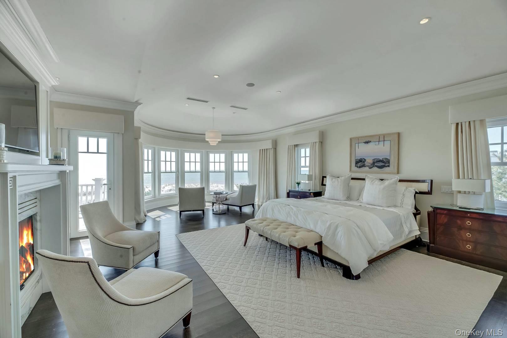 19 Dune Road East Quogue, NY 11959 - Photo 13 of 19 a spacious bedroom with a bed and large windows