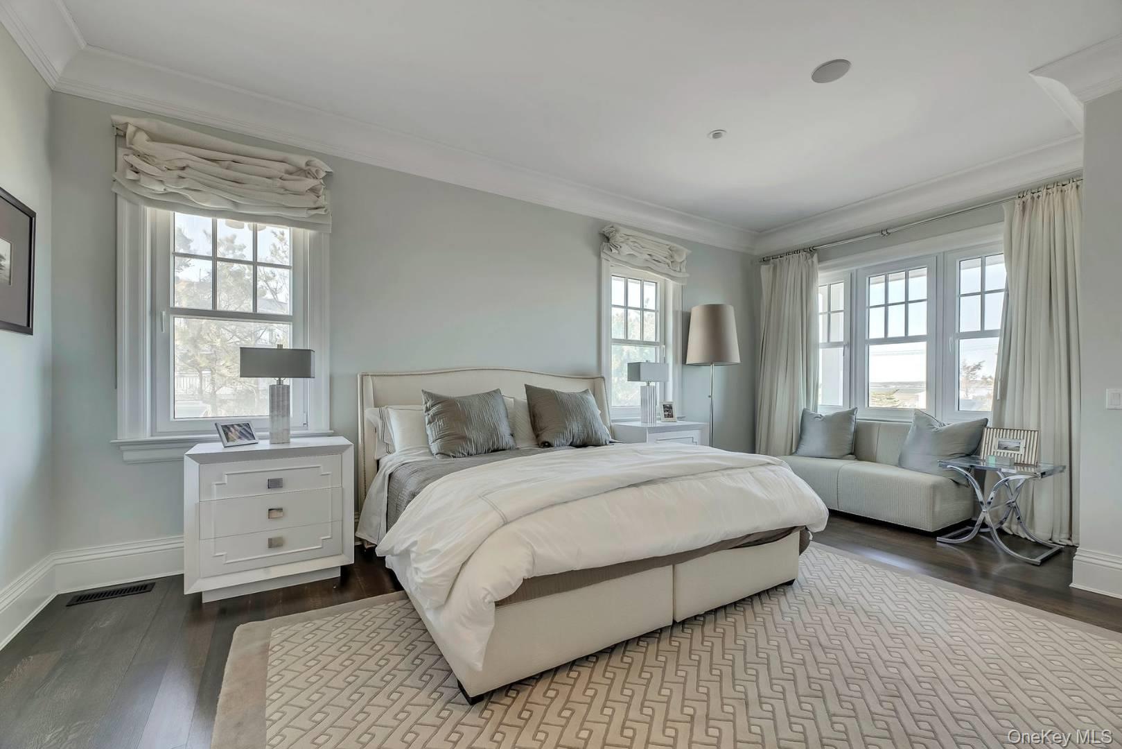 19 Dune Road East Quogue, NY 11959 - Photo 14 of 19 a spacious bedroom with a bed and a large window