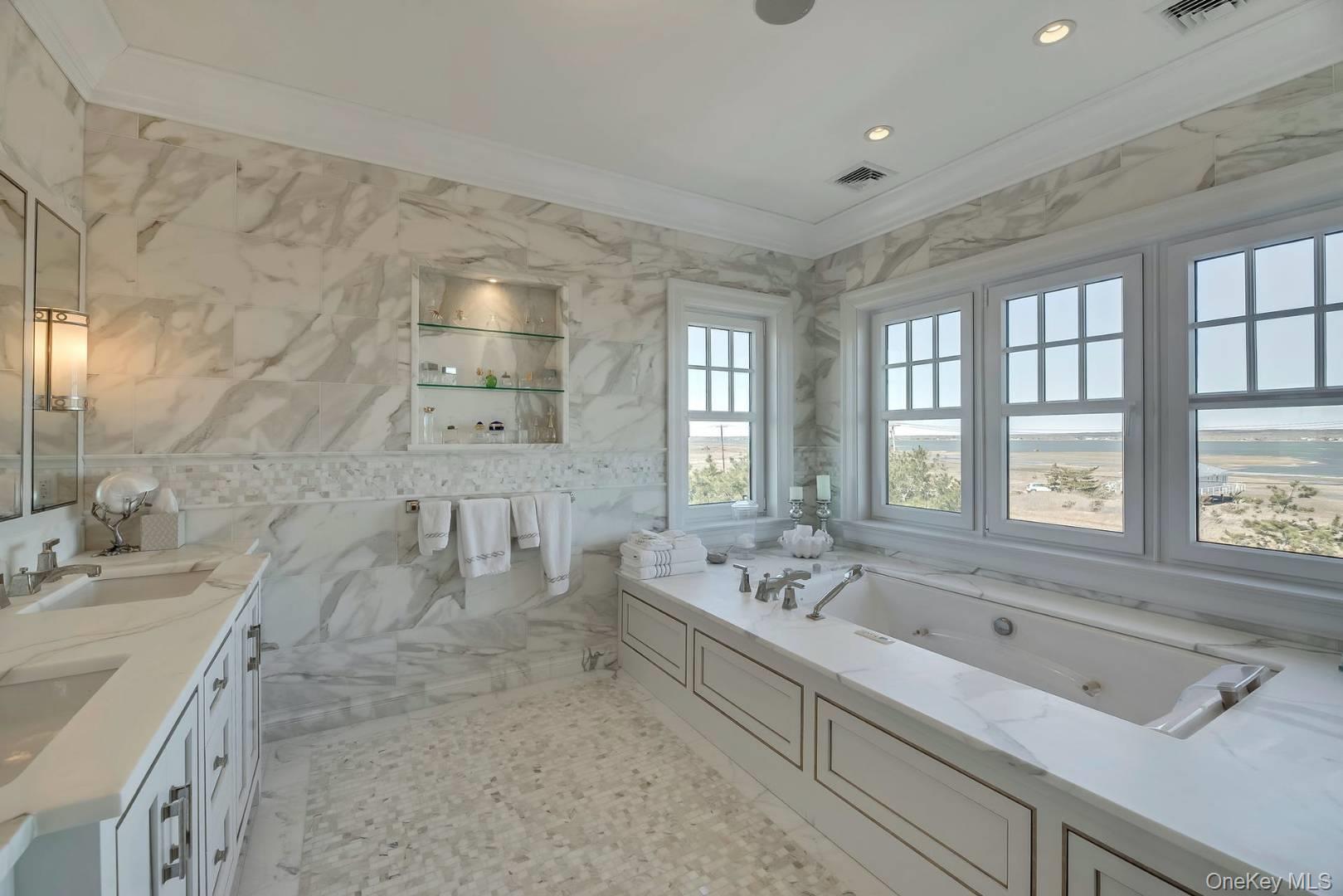 19 Dune Road East Quogue, NY 11959 - Photo 16 of 19 a spacious bathroom with double vanity and a bathtub