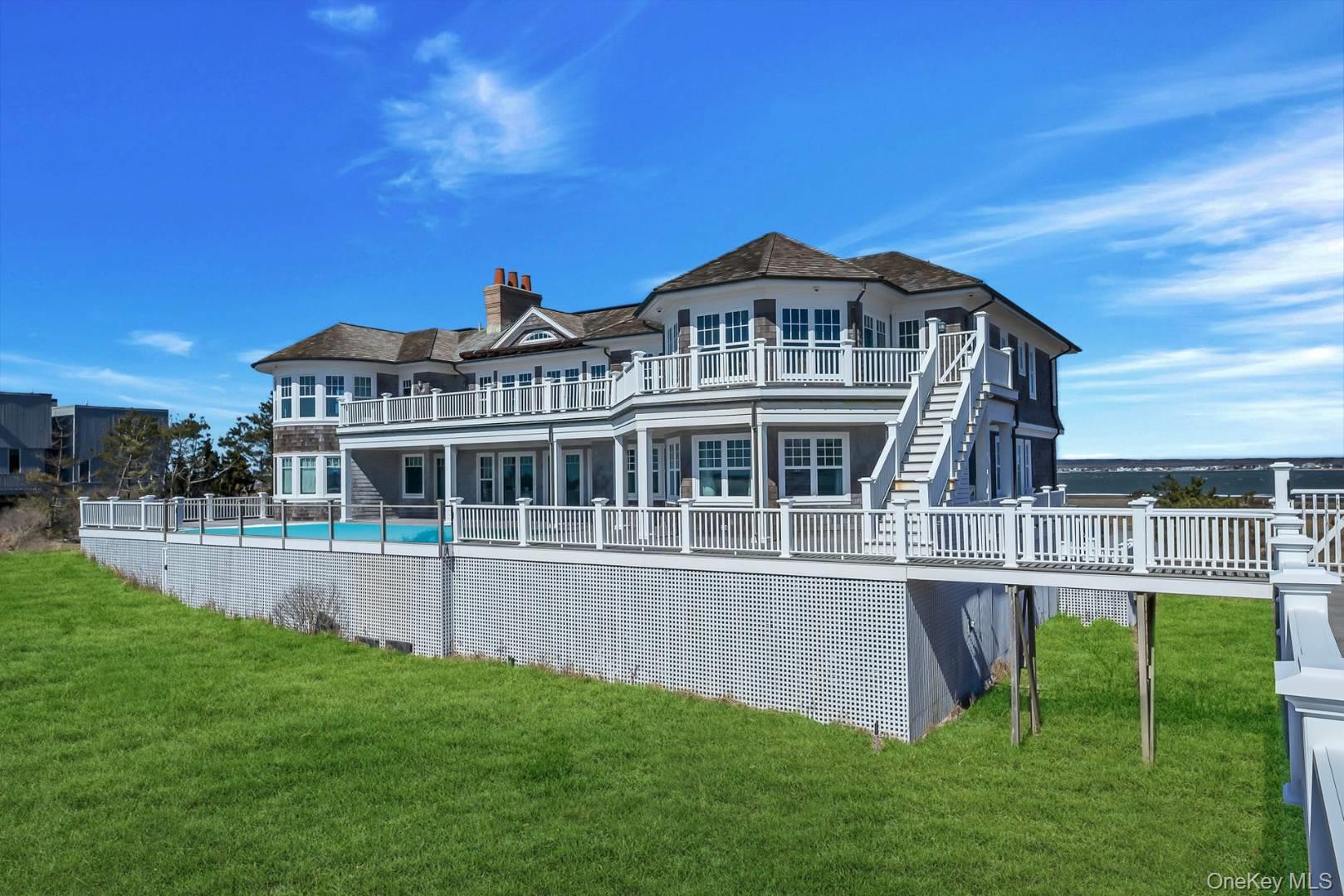 19 Dune Road East Quogue, NY 11959 - Photo 18 of 19 a front view of a house with a yard