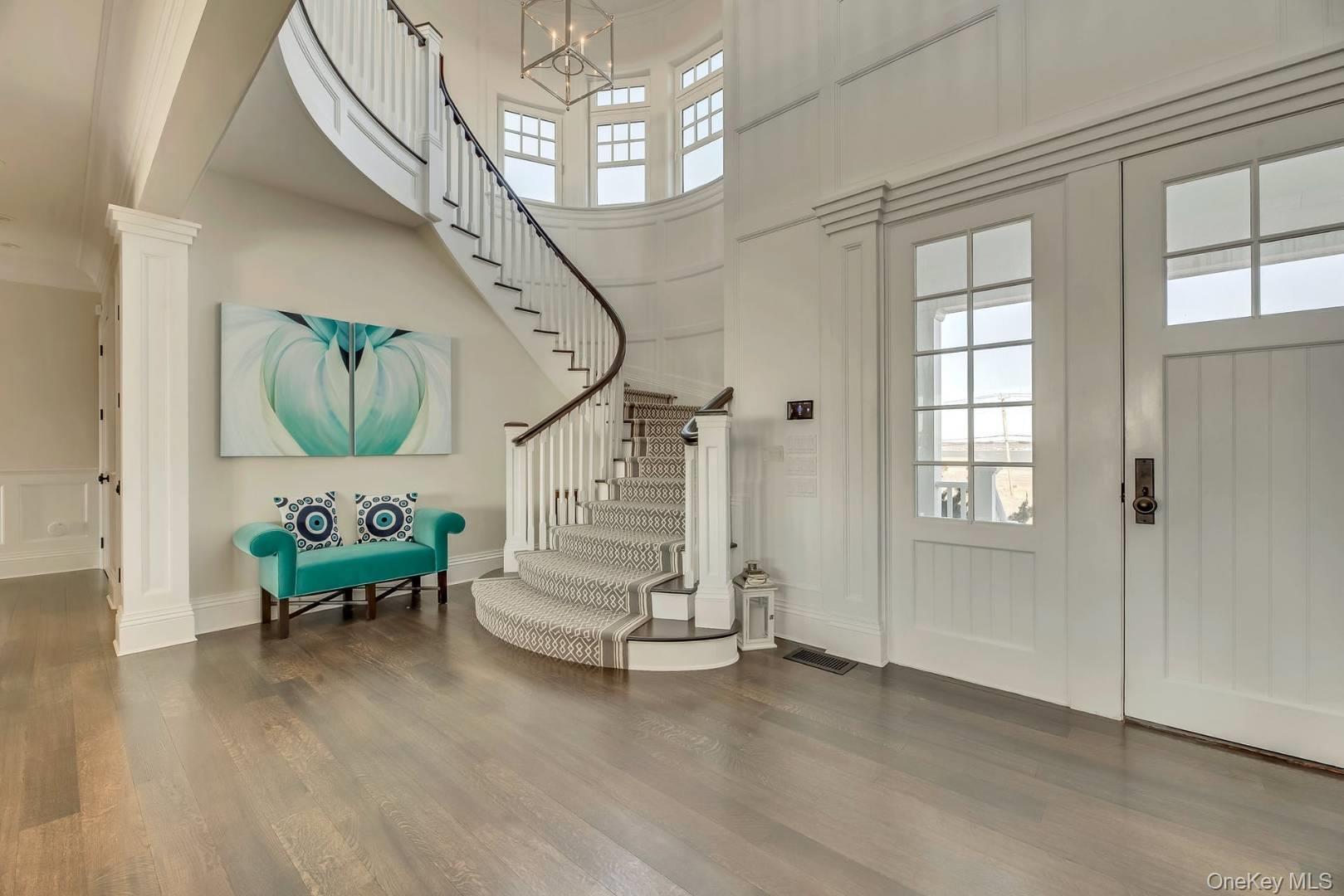 19 Dune Road East Quogue, NY 11959 - Photo 2 of 19 a living room with furniture and a chandelier