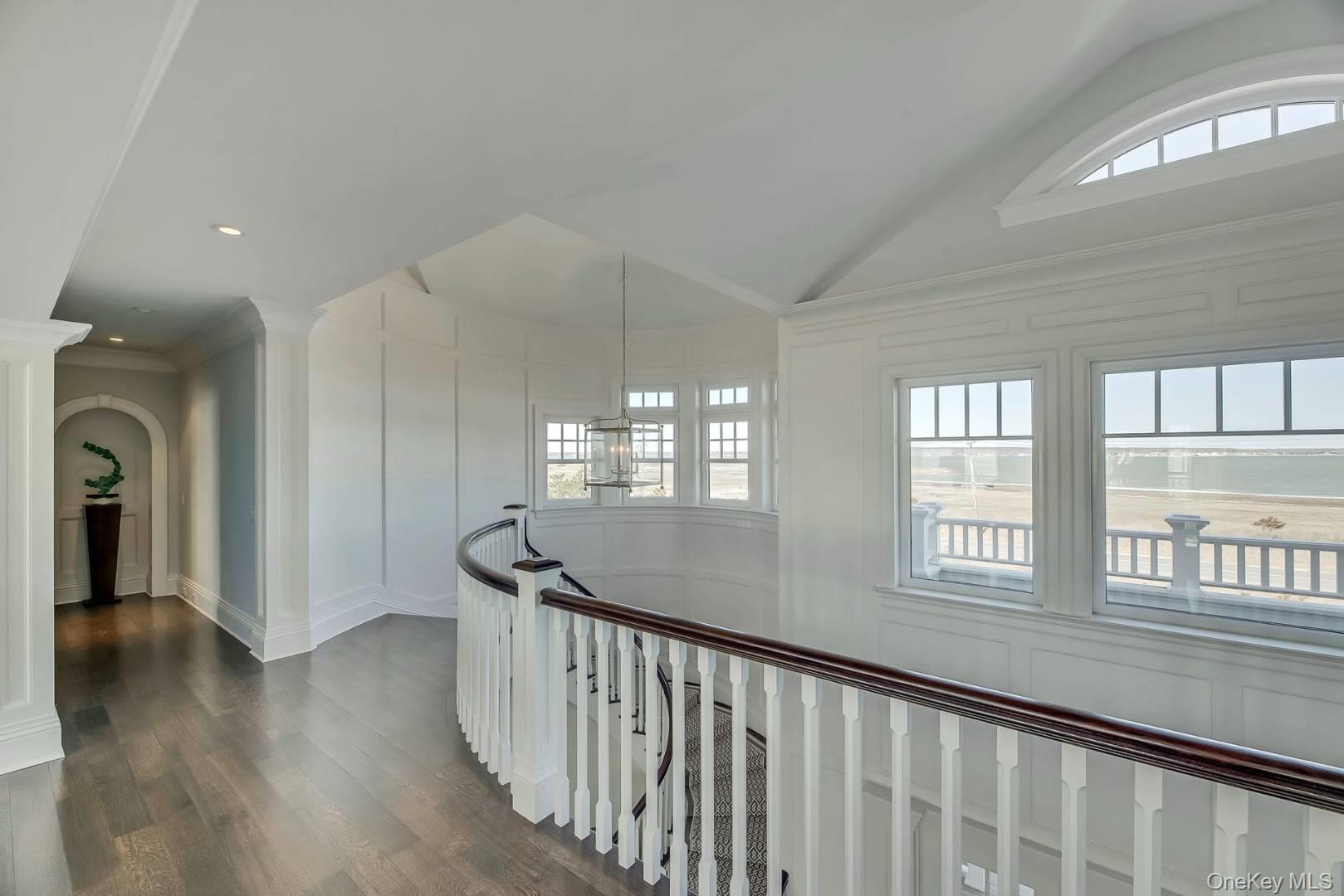 19 Dune Road East Quogue, NY 11959 - Photo 6 of 19 a view of an entryway with wooden floor and windows
