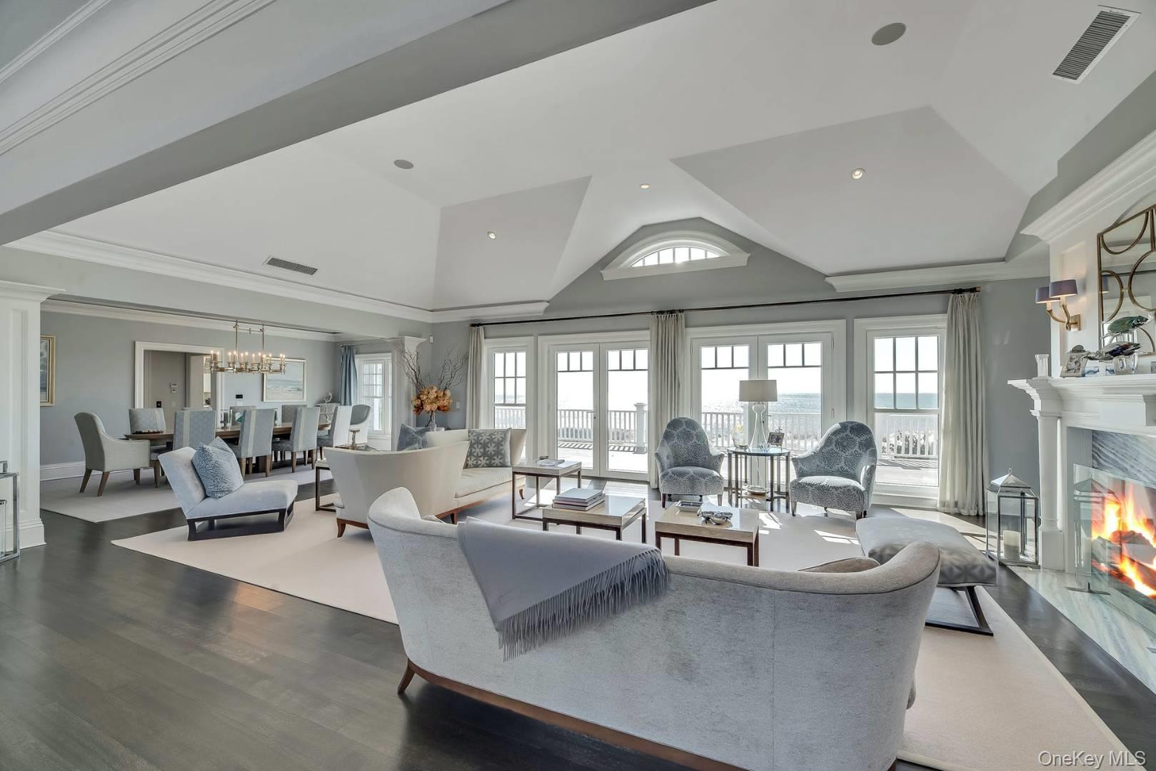 19 Dune Road East Quogue, NY 11959 - Photo 7 of 19 a living room with fireplace furniture and a large window