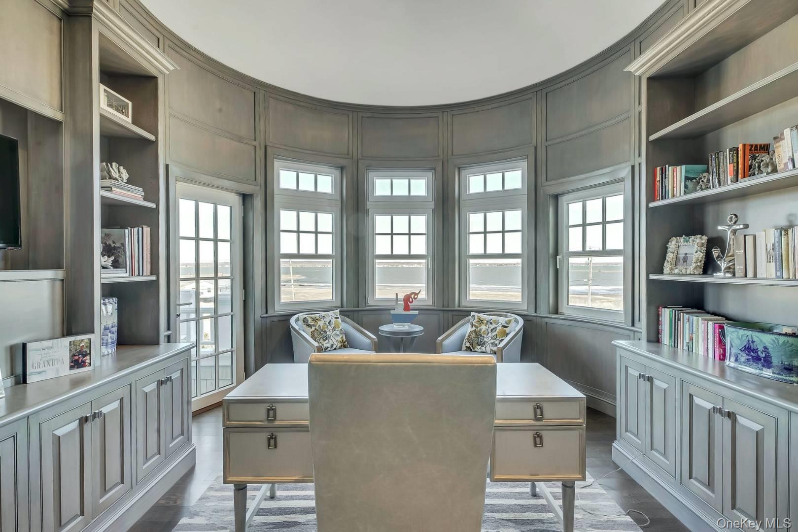 19 Dune Road East Quogue, NY 11959 - Photo 9 of 19 a living room with furniture and a book shelf