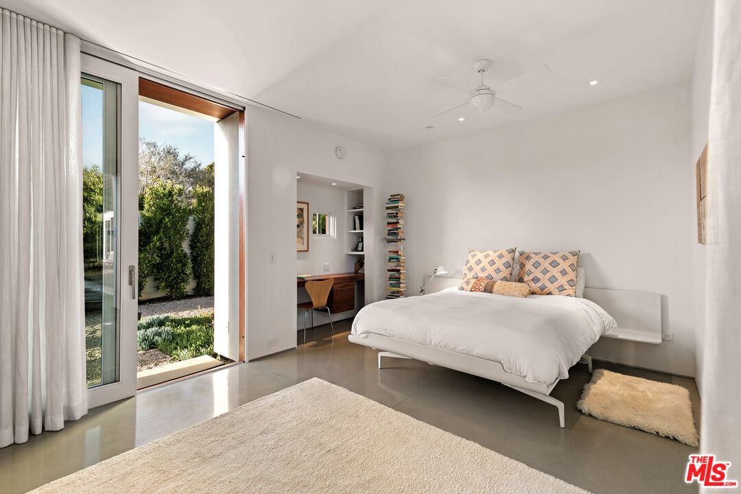6728 Wildlife Road Malibu, CA 90265 - Photo 22 of 57 a bedroom with a large bed and a large window