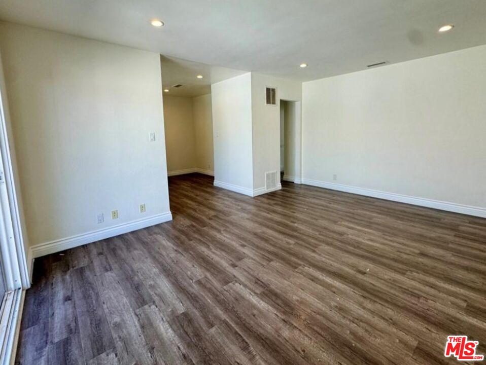 2040 South Sherbourne Drive, Unit 4 Los Angeles, CA 90034 - Photo 11 of 14 a view of an empty room with wooden floor