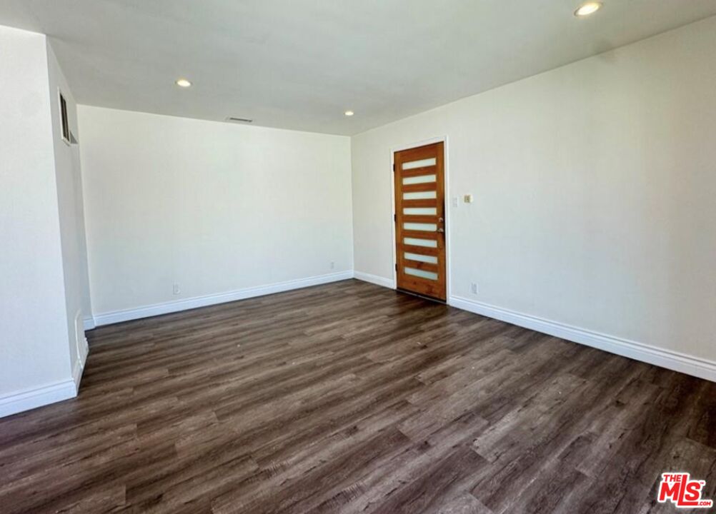 2040 South Sherbourne Drive, Unit 4 Los Angeles, CA 90034 - Photo 14 of 14 a view of an empty room with wooden floor