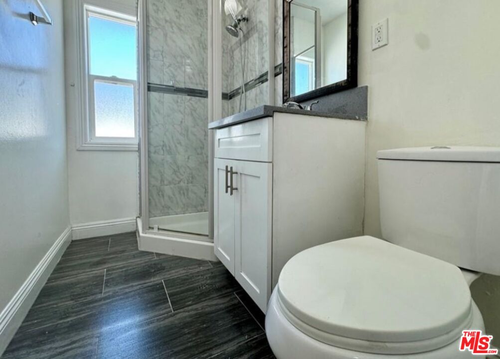 2040 South Sherbourne Drive, Unit 4 Los Angeles, CA 90034 - Photo 5 of 14 a bathroom with a toilet and a shower