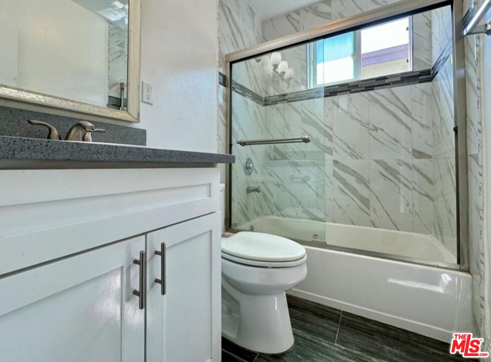2040 South Sherbourne Drive, Unit 4 Los Angeles, CA 90034 - Photo 8 of 14 a bathroom with a sink and a mirror