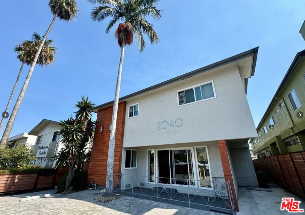 2040 South Sherbourne Drive, Unit 4 Los Angeles, CA 90034 - Photo 9 of 14 a front view of a house with a yard