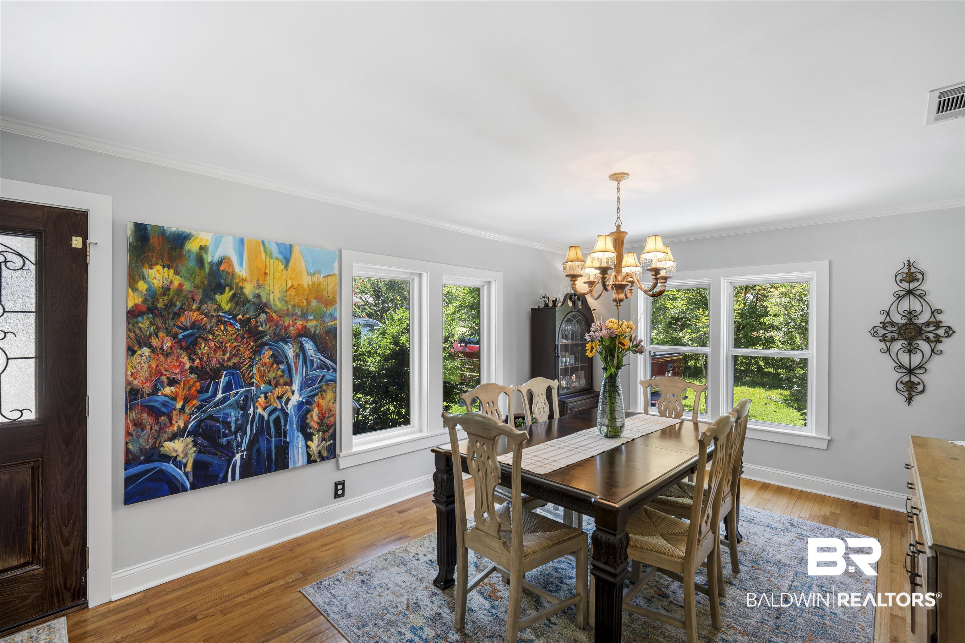 1615 5th Street Daphne, AL 36526 - Photo 4 of 28 Dining space featuring wood-finish flooring, white crown molding, and multiple windows