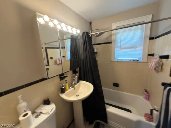 a bathroom with a sink mirror vanity and toilet
