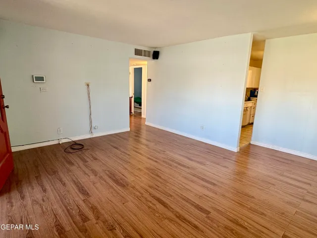 an empty room with wooden floor