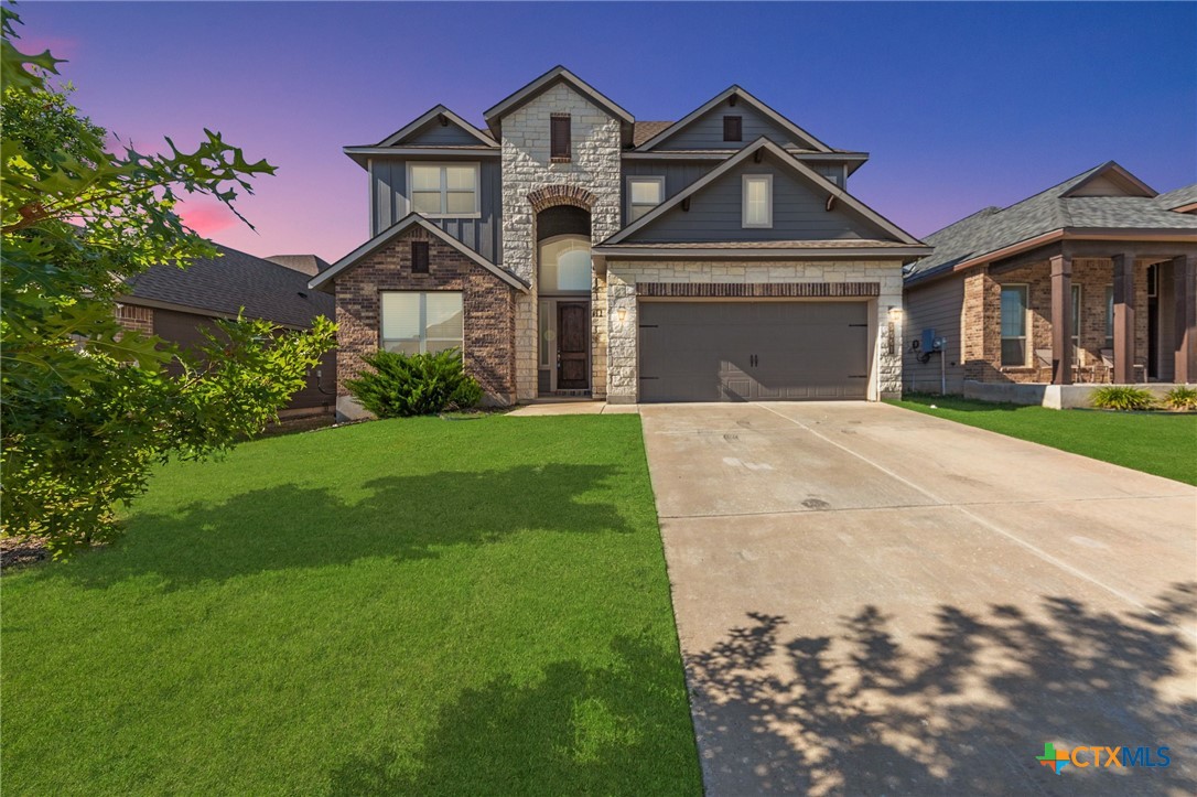 a front view of a house with a yard and garage