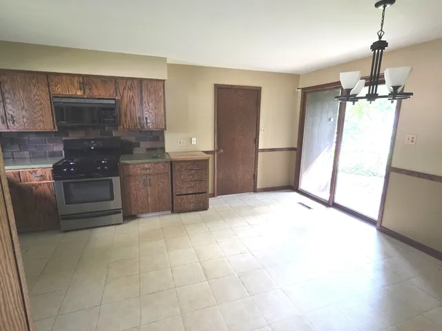 a kitchen with stainless steel appliances granite countertop a stove and a microwave
